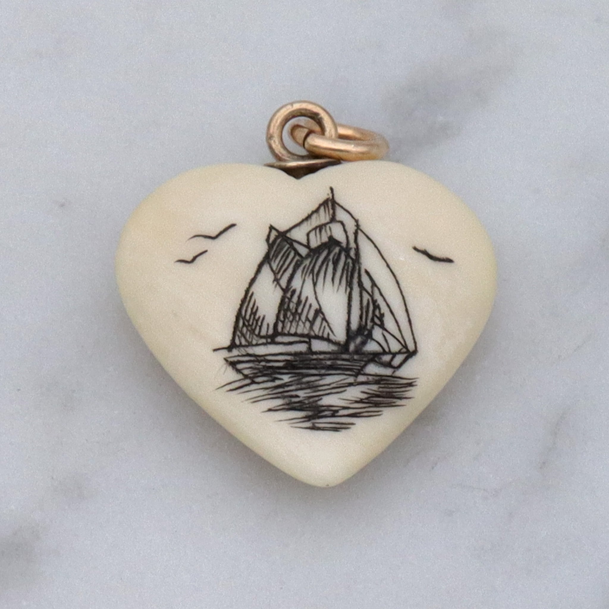 Antique hand carved faux ivory sailboat heart charm pendant